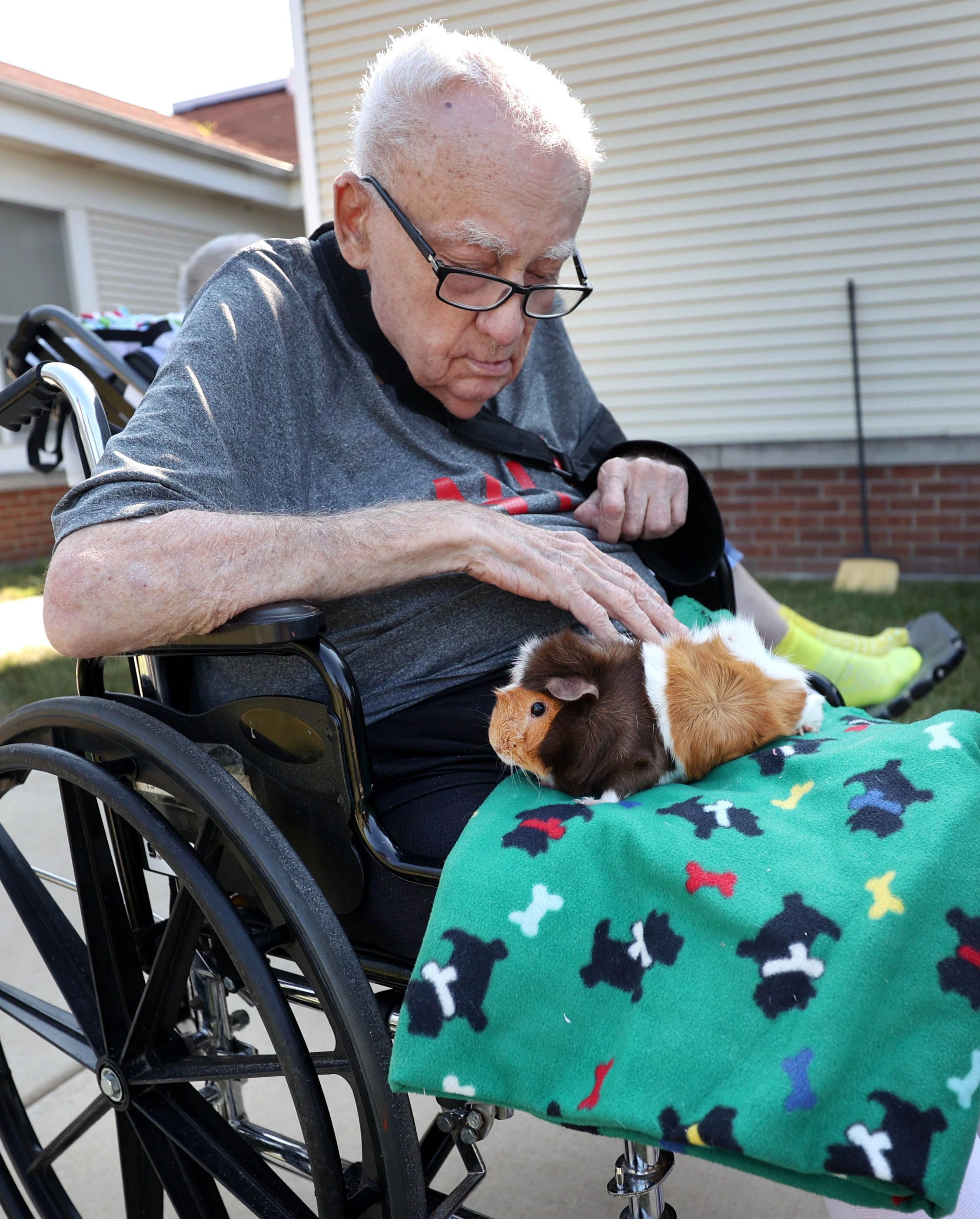A DeKalb County Rehab and Nursing Center resident spends some time with a guinea pig during a visit from Kate’s Kritters Mobile Petting Zoo Thursday, Sept. 18, 2025, at the facility in DeKalb.