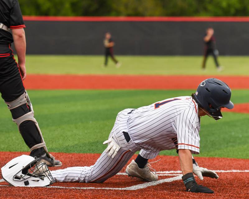 Romeoville's Jonny Lee (1) slides home for a run during the regional game against Yorkville on Thursday May 29, 2025, held at Yorkville High School.a