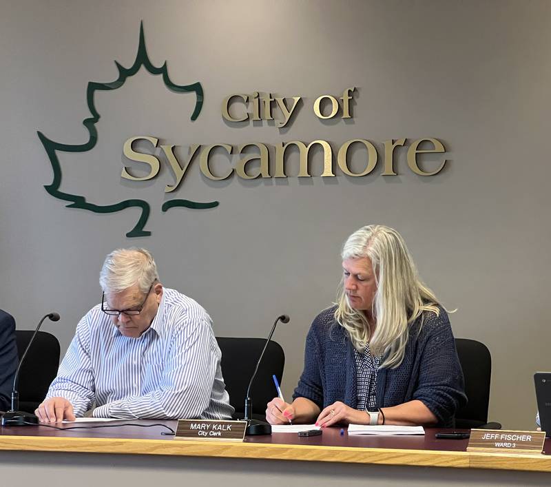 Sycamore Mayor Steve Braser looks down as Sycamore City Clerk Mary Kalk writes down votes during a City Council meeting on April 15, 2024.
