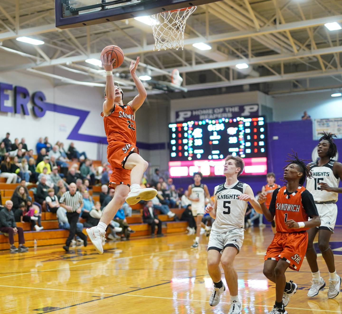 Sandwich’s Chance Lange (23) drives to the hoop against Kaneland's Brad Franck (5) during a first round basketball game in the 60th annual Plano Christmas Classic Tournament Plano High School on Wednesday, Dec 27, 2023.