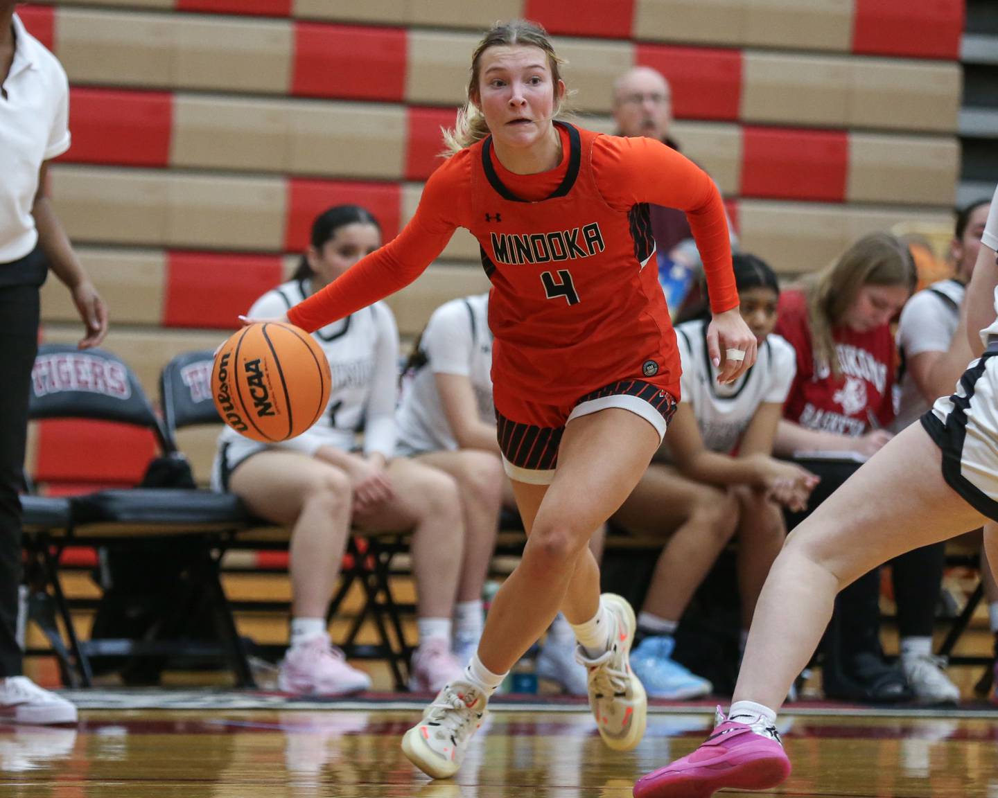 Minooka's McKenna Delaney (4) drives past the defense during their basketball game between Minooka at Plainfield North. Feb 06, 2025 in Plainfield.
