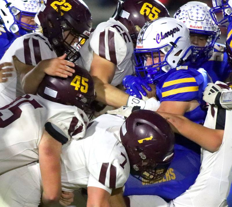Richmond-Burton’s defense swarms Aurora Central Catholic ballcarrier Trey Seifrid in IHSA football Class 3A second-round playoff action at Bob Stewart Field on the campus of Aurora Central Catholic High School in Aurora on Friday, November 7, 2025.