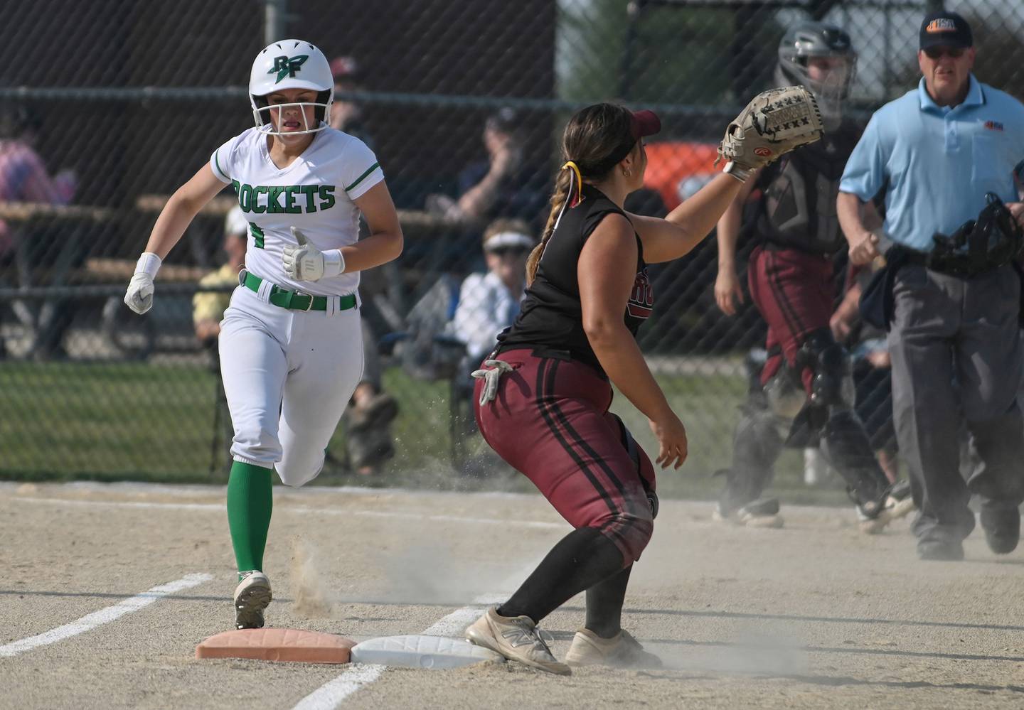 Rock Falls batter Olivia Osborne is thrown out by a step at first as Richmond Burton's Norah Spittler makes the play during Tuesday's sectional semifinal in Davis Junction.
