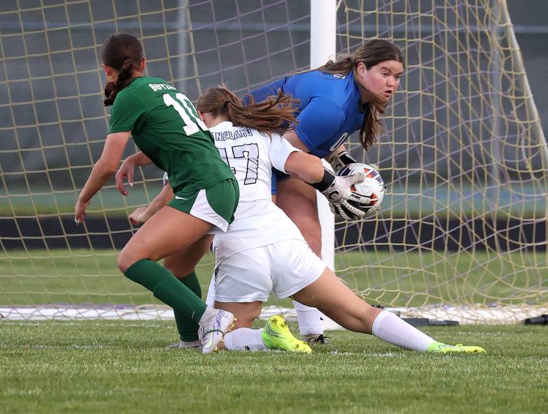 Kaneland's Natalie Myers makes as save as Kaneland's Audrey Noring and Boylan's Ava Galluzzo collide in front of her Wednesday, May 28, 2025, during their Class 2A sectional semifinal game at Belvidere High School.