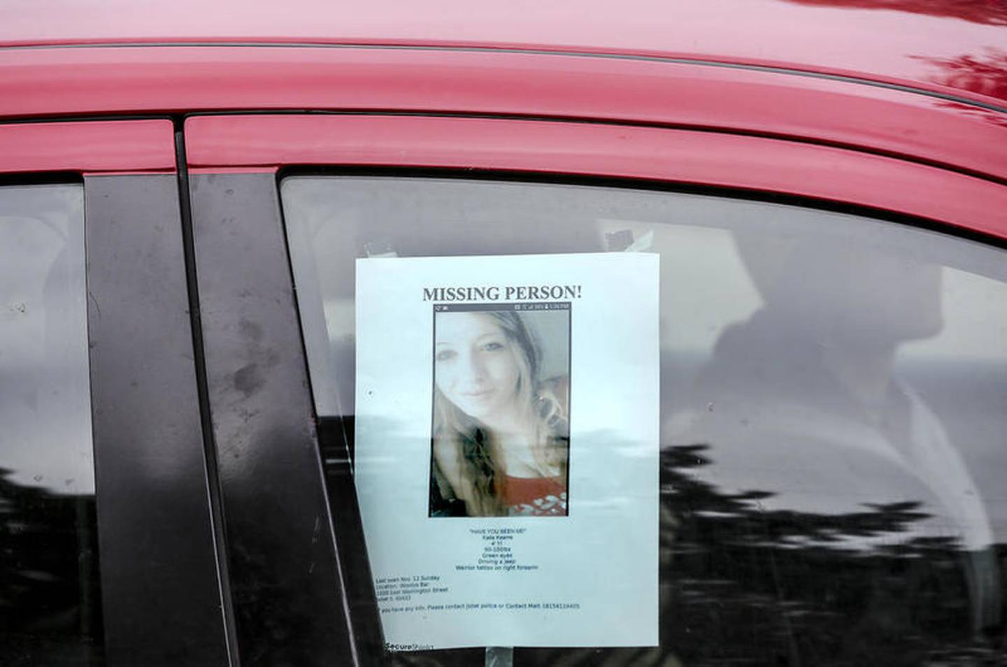 A missing persons flyer hangs in the window of Marie Roche's window Thursday, Nov. 16, 2017, after Kaitlyn Kearns, a 24-year-old bartender from Joliet, was found dead from a gunshot in a rural area of Kankakee County, according to a sheriff’s office news release.