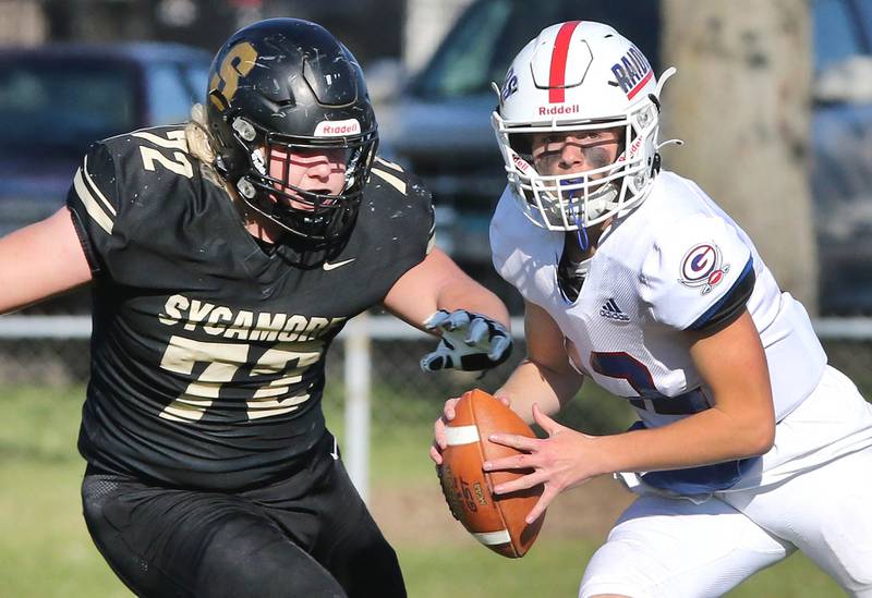 Glenbard South quarterback Michael Champagne is pressured by Sycamore's Lincoln Cooley