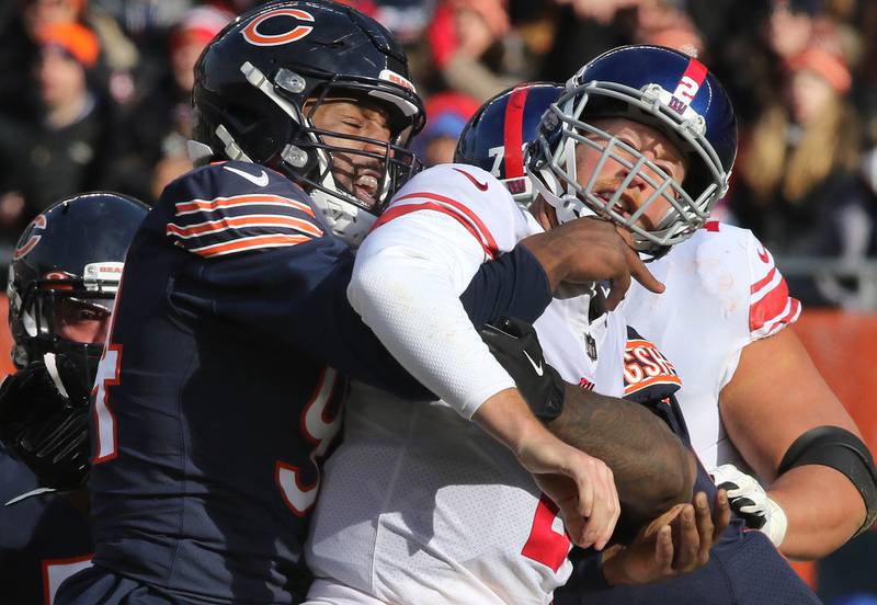 Chicago Bears outside linebacker Robert Quinn hits New York Giants quarterback Mike Glennon just as he passes the ball during their game Sunday, Jan. 2, 2021, at Soldier Field in Chicago.