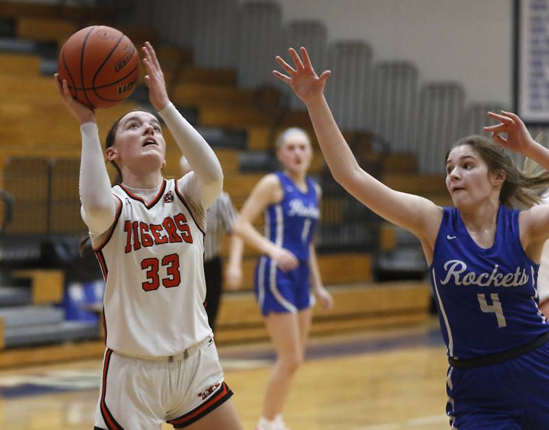 Crystal Lake Central's Katie Hamill drives to the basket against Burlington Central's Emersyn Fry during the IHSA Class 3A Woodstock Regional Championship girls basketball game on Thursday, Feb. 15, 2024, at Woodstock High School.