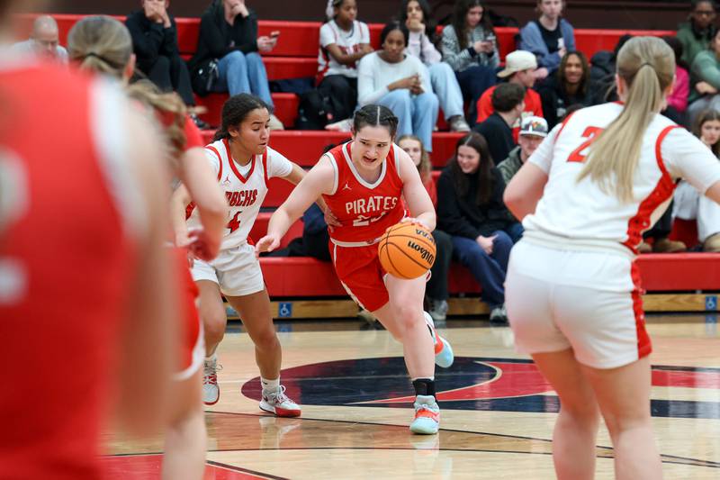 Ottawa's Mary Stisser drives to the lane against Bradley-Bourbonnais' Nia Lawrence during Ottawa's 55-44 victory on Monday, Feb. 9, 2026.