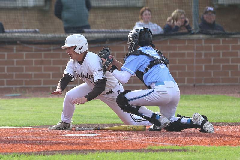 Nazareth’s Marco Fiore tags out Joliet Catholic’s Evan Wills trying to score on Wednesday, April 29, 2026 in Joliet.