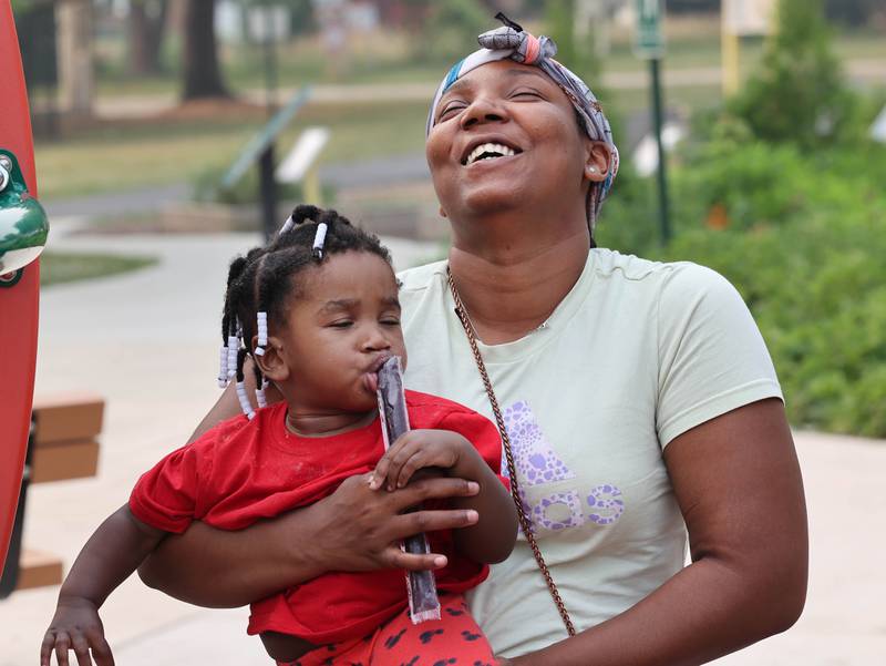 Armani Hood, from DeKalb hold her niece Jalaiyah Jackson, 1, as she enjoys an ice treat during Fun Jam in the Park Tuesday, June 27, 2023, at Welsh Park in DeKalb. Fun Jam in the Park offers constructive activities for kids on Tuesday and Thursday through August 8th from 5-7 p.m. at various parks in DeKalb.