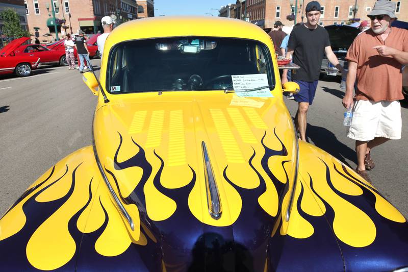 Visitors check out a 1948 Ford two-door Coupe Deluxe on State Street in Sycamore Sunday, July 31, 2022, during the 22nd Annual Fizz Ehrler Memorial Car Show.