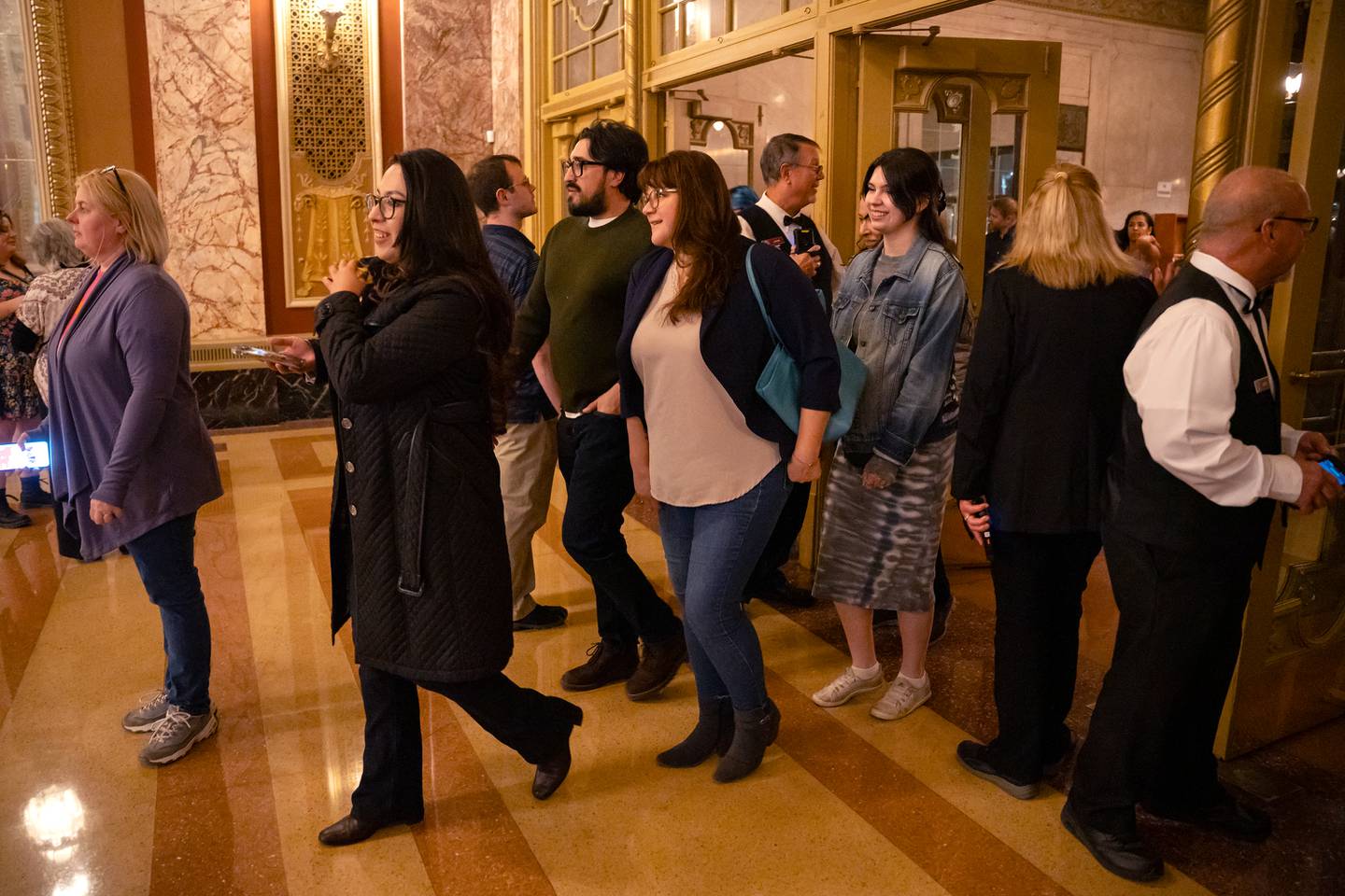 Concert attendees for the Vitamin String Quartet enter the lobby for the reopening of the Rialto Square Theatre in Joliet, Ill. on Tuesday Oct. 22, 2024