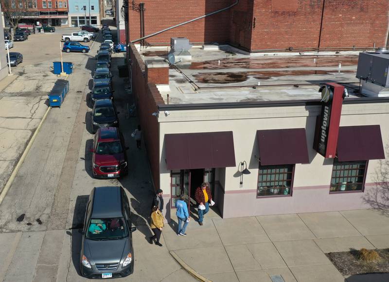 A long line of vehicles wait for carryout meals during the 24th annual spaghetti dinner on Monday, March 27, 2023 at Uptown.