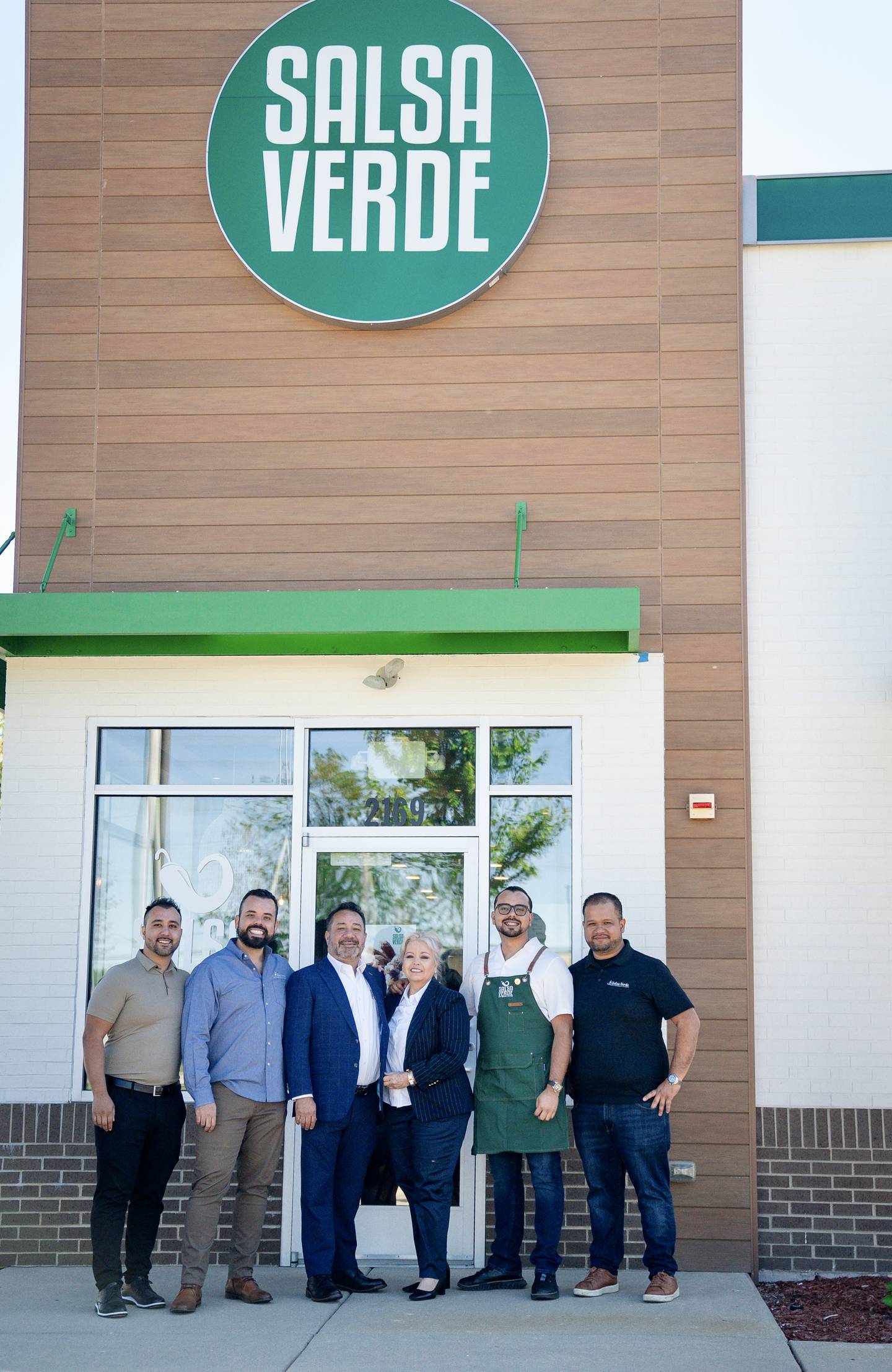 Salsa Verde owner Carlos Arechiga, family and staffers of the Mexican restaurant pose outside their dining locale. The business has expanded to 15 locations in Illinois and Indiana, including in St. Charles and Carpentersville.