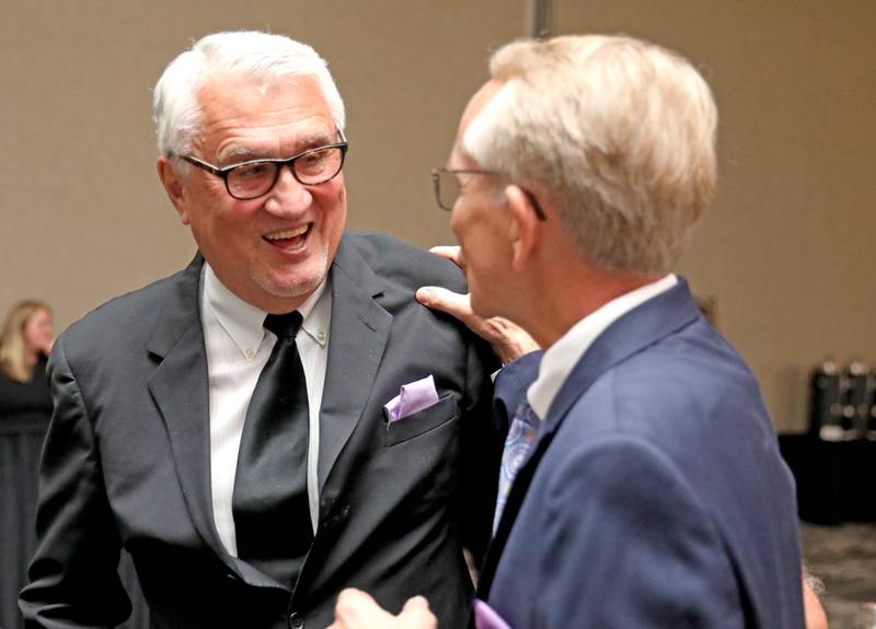 Former St. Charles Mayor Ray Rogina (left) greets former St. Charles Administrator Mark Koenen after Rogina was announced as the 2022 Charlemagne Award winner during the 100th Annual Charlemagne Gala at the Q Center in St. Charles on Friday, May 13, 2022.