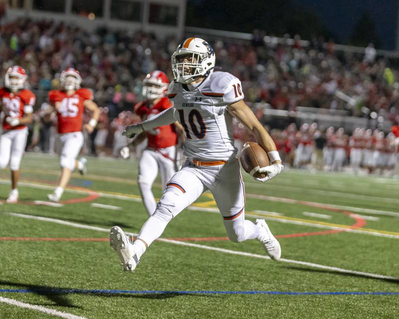 Oswego's Mariano Velasco (10) leaps into the endzone during football game between Oswego at Naperville Central  on Friday, Aug 29, 2025  in Naperville.
