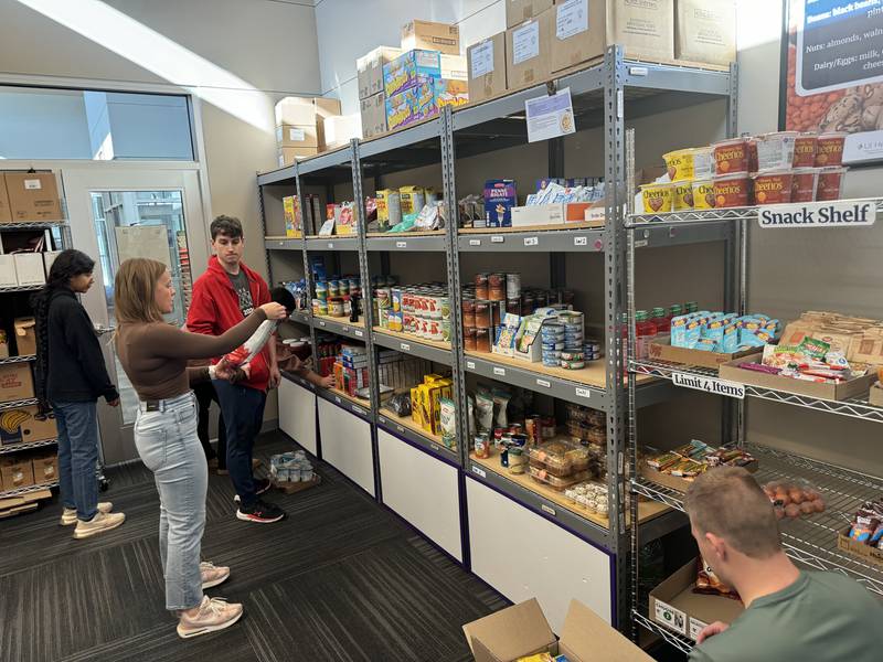 Volunteers from Illinois Valley Community College’s Project Success help Associate Director of Retention Ashlee Fitzpatrick restock the Eagles Peak Food Pantry in preparation for a new semester. The pantry has supplied a growing list of students and their families since it was expanded and relocated two years ago.