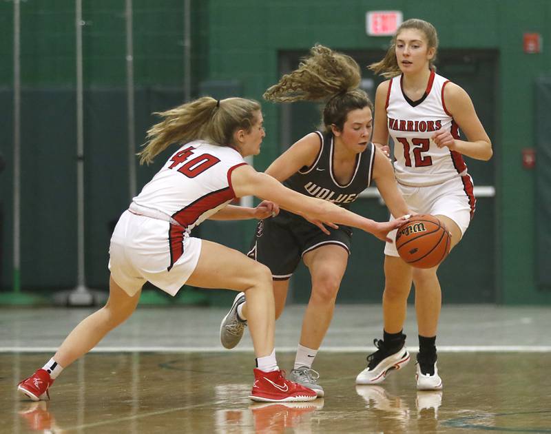 Prairie Ridge's Elani Nanos tries to bring the ball up the court against Deerfield's Morgan Kerndt, left, and Kate Trella, right, during a IHSA Class 3A Grayslake Central Sectional semifinal basketball game Tuesday evening, Feb. 22, 2022, between Prairie Ridge and Deerfield at Grayslake Central High School.