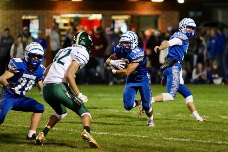 Princeton's Augie Christiansen takes a hand off from Teegan Davis Friday Night at Bryant Field. The Tigers won 56-7.