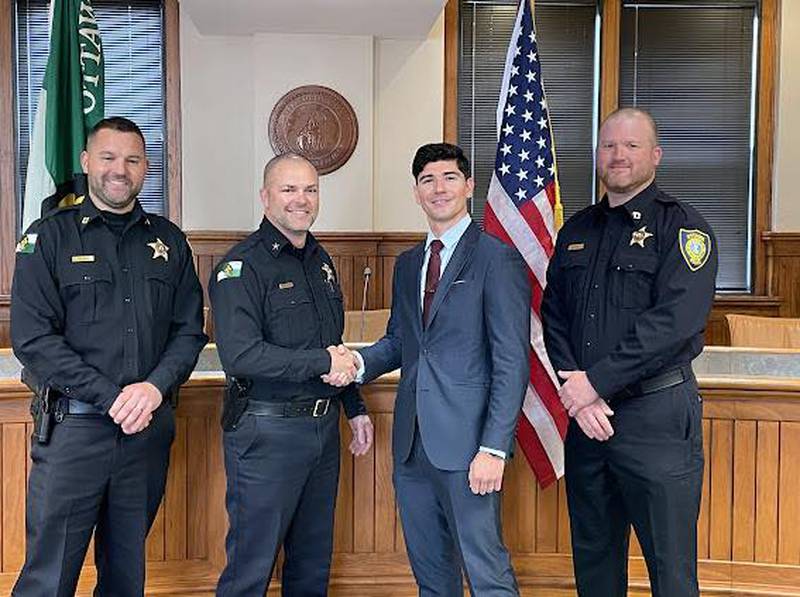 Newly sworn-in Ottawa Police Officer Alex Mata poses for a photo with Chief Mike Cheatham, Capt. Kyle Booras, and Capt. Marc Hoster on Friday, May 2, 2025, at City Hall.
