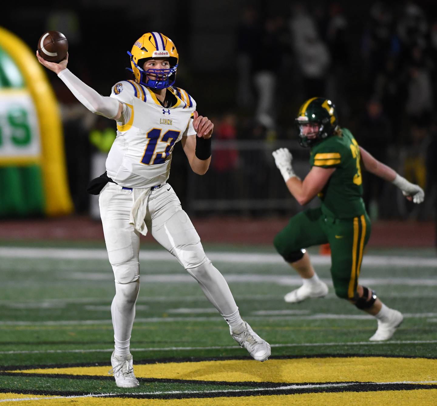Lyons Township quarterback Jack Slightom throws a pass during a second-round Class 8A football playoff game against Fremd in Palatine Friday.