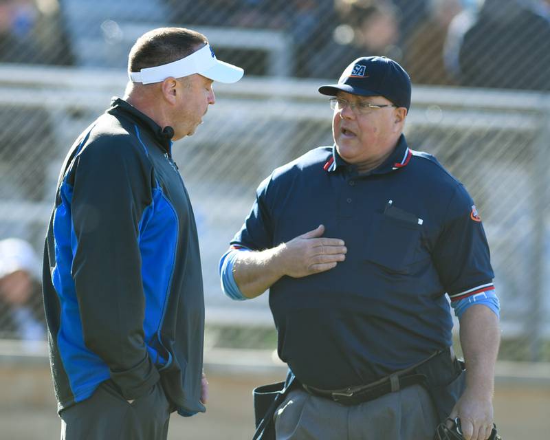 St. Charles North's head coach Tom Poulin talks with the home plate umpire after an out was overturned during the game on Wednesday April 24, 2024, while traveling to take on Lake Park High School.