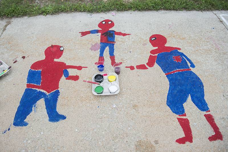 Many colorful works of art can be admired on the sidewalk of the old Lee County Courthouse as part of Petunia Fest’s Brush and Bloom event.