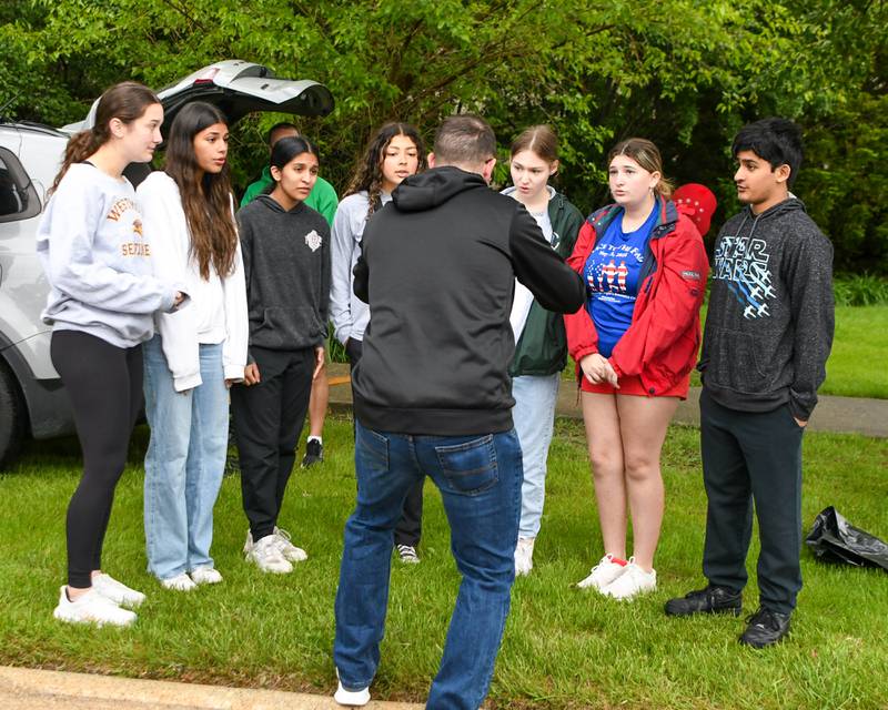 Westmont choir members sing the National Anthem on Sunday May 25, 2025, before the start of the race To The Flag 5k held at Ty Warner Park in Westmont.