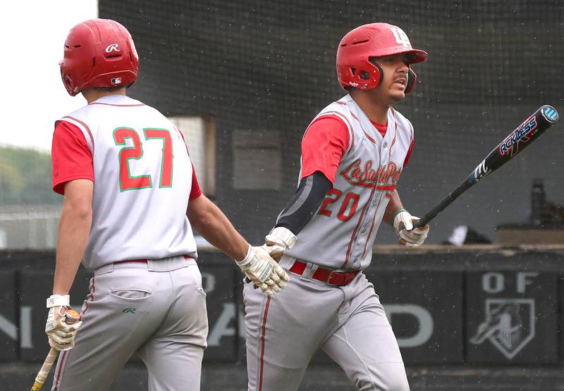 LaSalle-Peru's Monti Lorenzi (right) is congratulated after scoring a run by teammate Grey Ernat Tuesday, May 12, 2026, during their game at Kaneland High School in Maple Park.