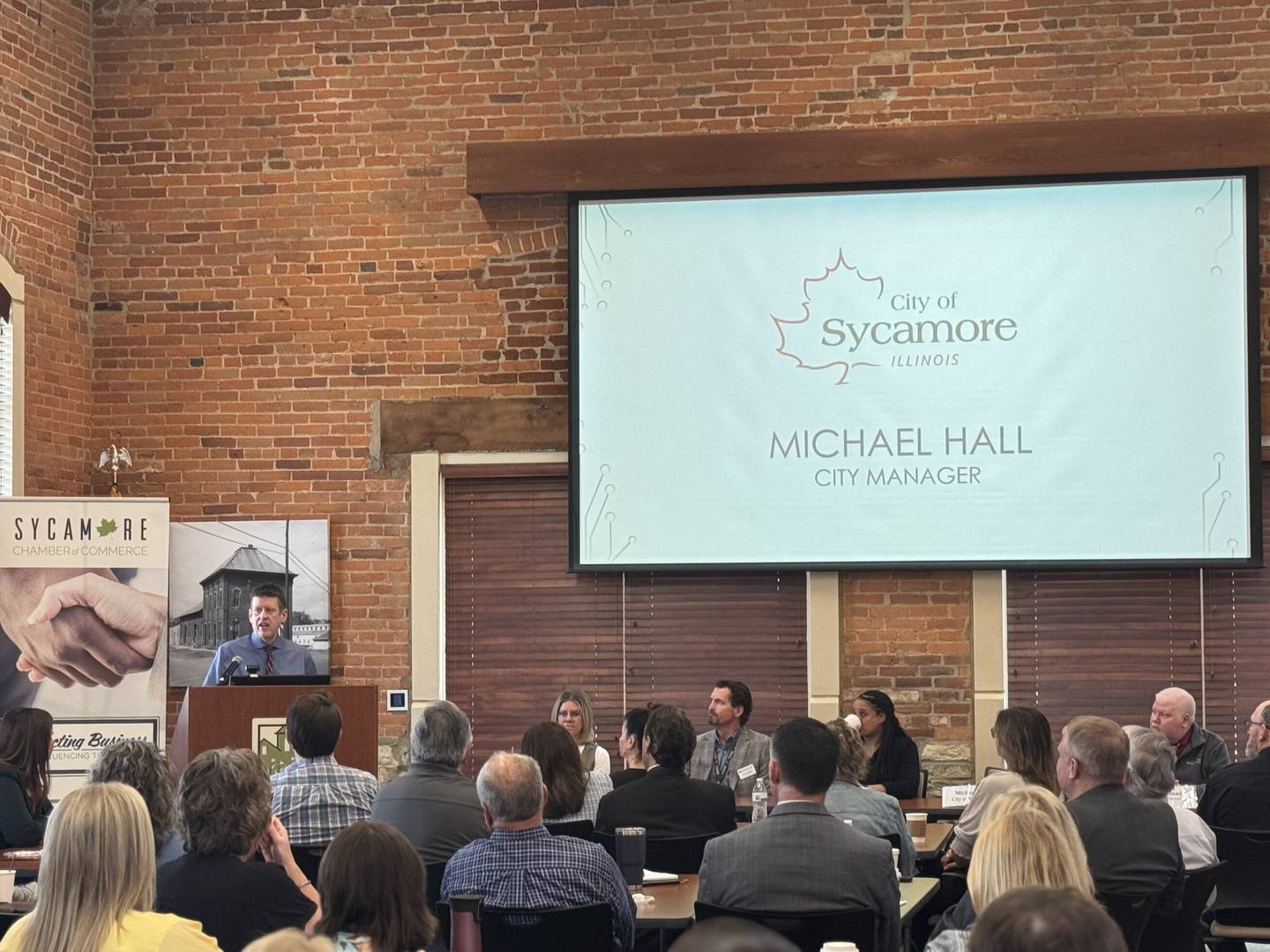 Sycamore City Manager Michael Hall speaks to a crowd on Wednesday, May 6, 2025, at the Sycamore Community Foundation building to provide dozens of area residents with updates on goals for the city and ongoing initiatives. The Sycamore Chamber of Commerce hosted its annual State of the Community event.