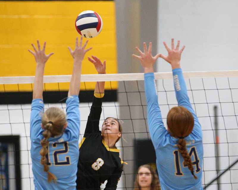 Putnam County's Ava Hatton spikes the ball past Marquette's Lilly Craig and teammate Maera Jimenez on Thursday, Sept 7, 2023 at Putnam County High School.