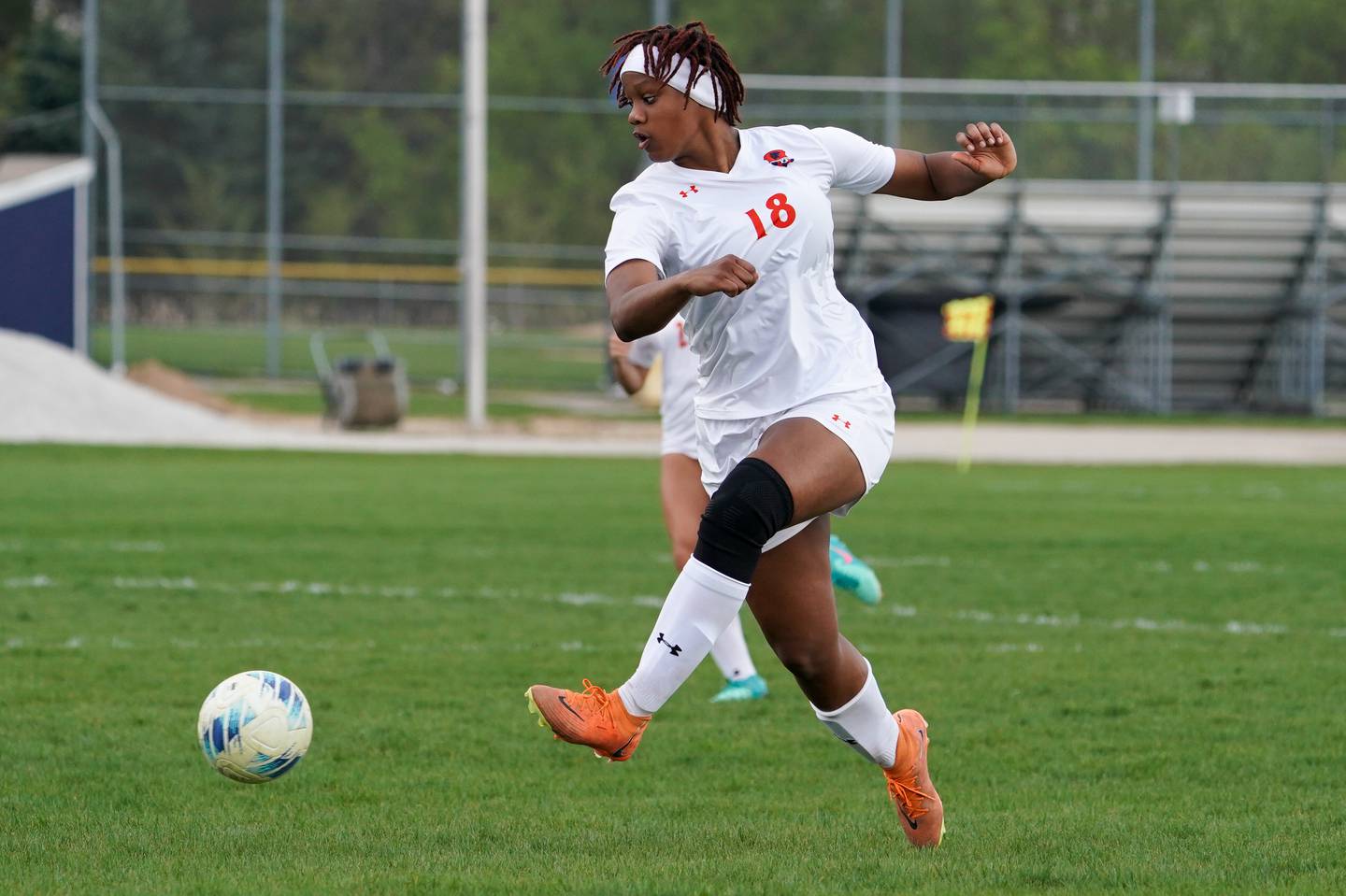 Oswego’s Jordyn Washington (18) shoots the ball against Oswego East during a soccer match at Oswego East High School on Tuesday, April 23, 2024.