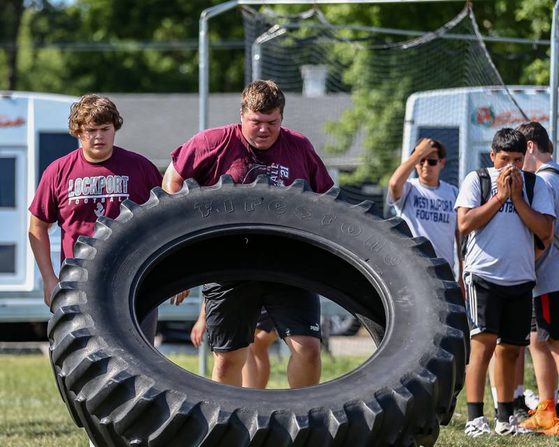 Lockport competes in the tire flip at the West Aurora High School Battle of the Big Butts Linemen Challenge.  July 14, 2022.
