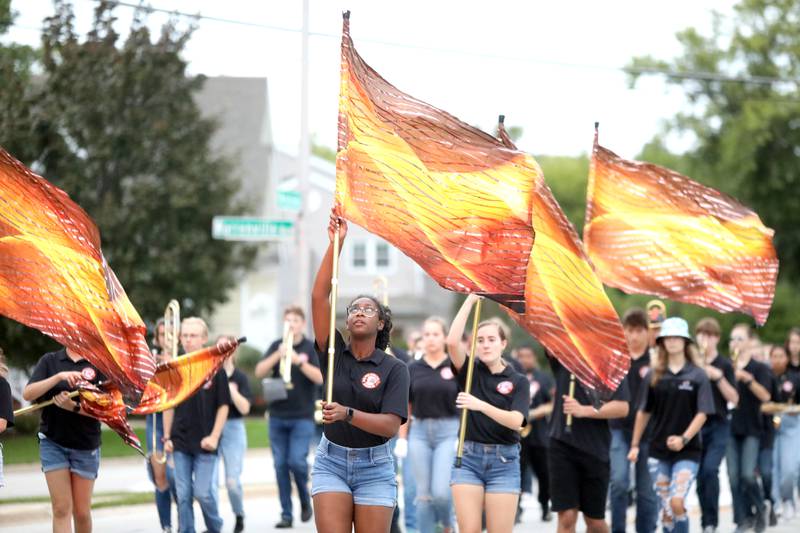 Members of the Wheaton Warrenville South flag corps perform during the school’s homecoming parade on Wednesday, Sept. 21, 2022.