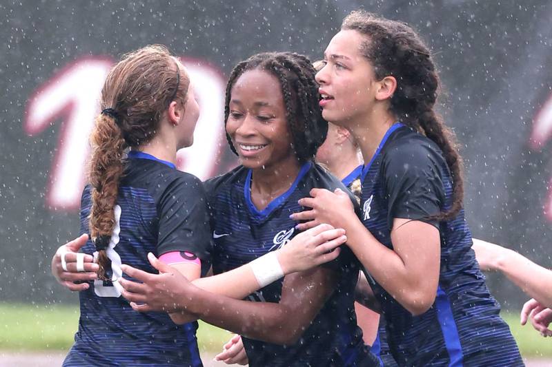 Burlington Central's Mekenzie Rogers (middle) is congratulated by teammates after she scored during their third place game against Peoria Notre Dame Saturday, June 1, 2024, at the IHSA Class 2A state soccer finals at North Central College in Naperville.