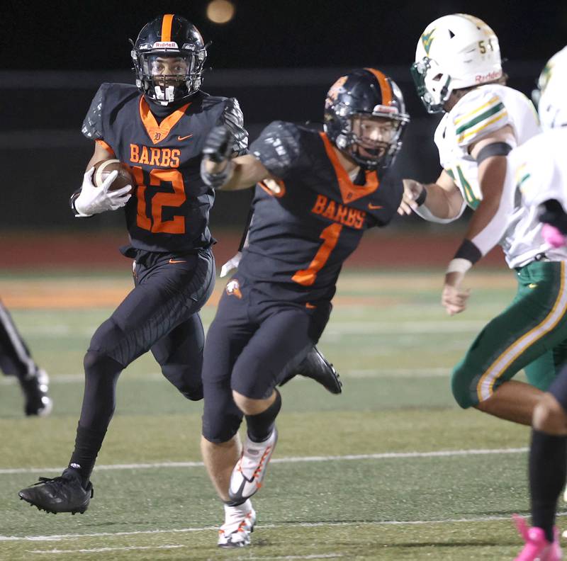 DeKalb's Ethan McCarter follows the blocking of Talen Tate as he carries the ball during their game against Waubonsie Valley Thursday, Oct. 20, 2022, at DeKalb High School.