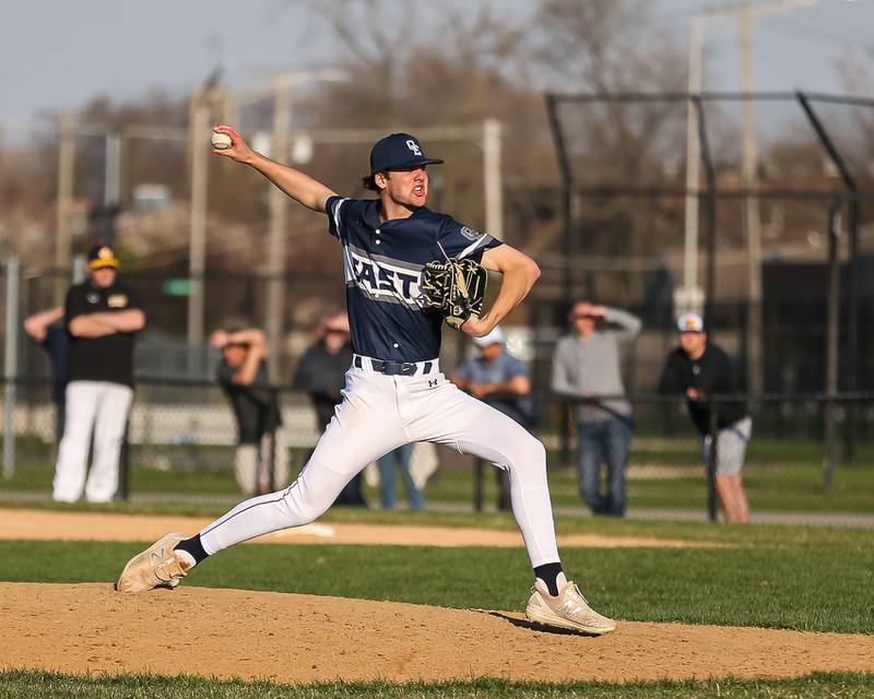 Oswego East's Griffin Sleyko (21) delivers a pitch during varsity baseball game between Oswego East at Joliet West.  April 10, 2023.