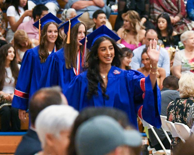 Graduates make their way into the gym at Glenbard South High School at the start of the graduation ceremony on Thursday May 23, 2024.
