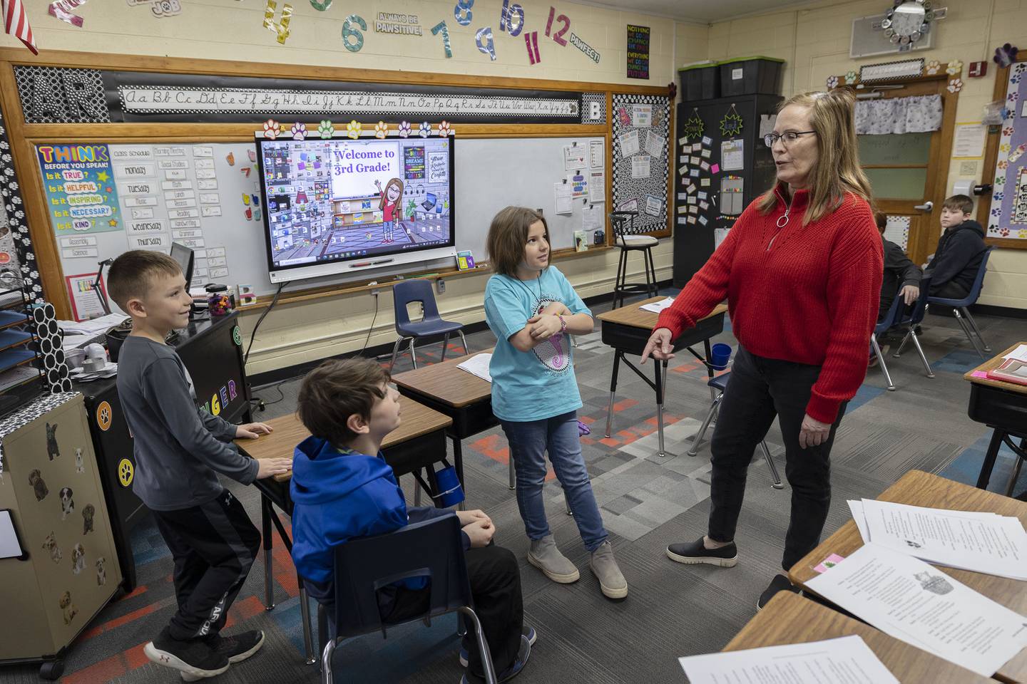 East Coloma-Nelson third-grade teacher Lisa Brininger works with her class on a reading and discussion assignment Friday, March 24, 2023.