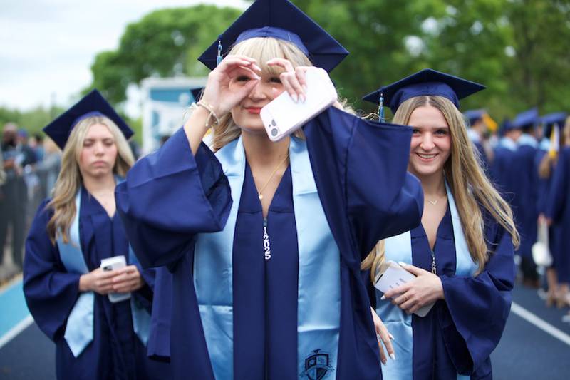 Downers Grove South graduates  looking for their family at the Commencement Ceremony on Sunday, May 18, 2025 in Downers Grove.