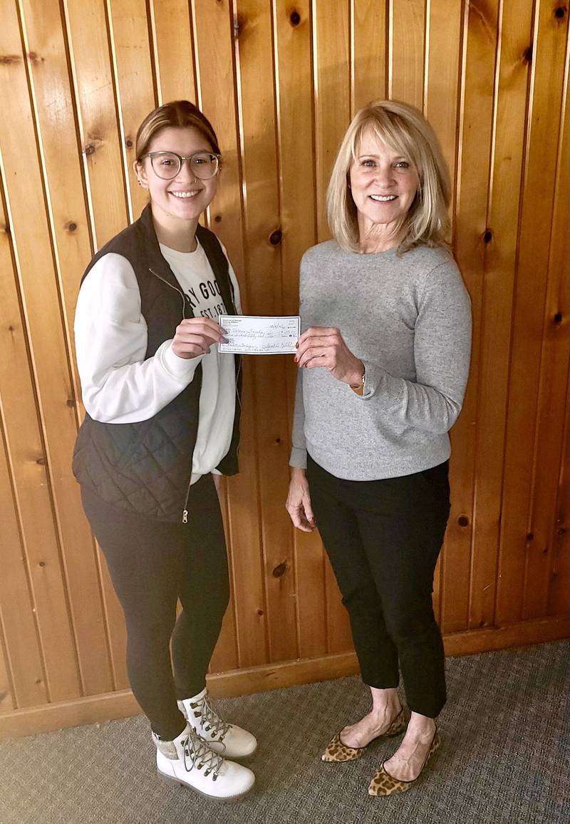 Rock Falls Rotary Community Service Co-Chairwoman Darla Ewing (right) presents a check for $250 to Jada Saffell for the Coloma Township Thanksgiving Basket project. The Rotary Club supports worthwhile causes in the Rock Falls community.