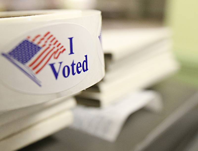 An "I Voted" sticker rests on top of a ballot machine at Zion United Church of Christ on Tuesday, Nov. 8, 2022 at Zion United Church of Christ in Peru.