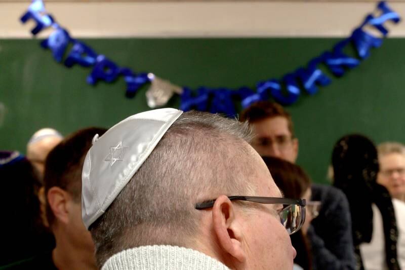 Michael DiPasqua of Crystal Lake visits with others during a Chanukah party at The McHenry County Jewish Congregation Sunday.