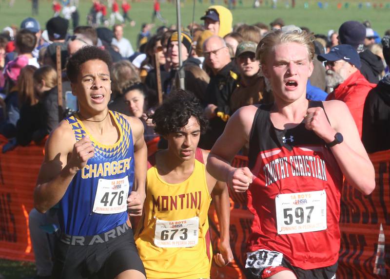 Aurora Central Catholic's Jacob Gray, Montini's Adrieal Garcia, and Timothy Christian's Josh Bemister compete in the Class 1A State Cross Country race on Saturday, Nov. 4, 2023 at Detweiller Park in Peoria.