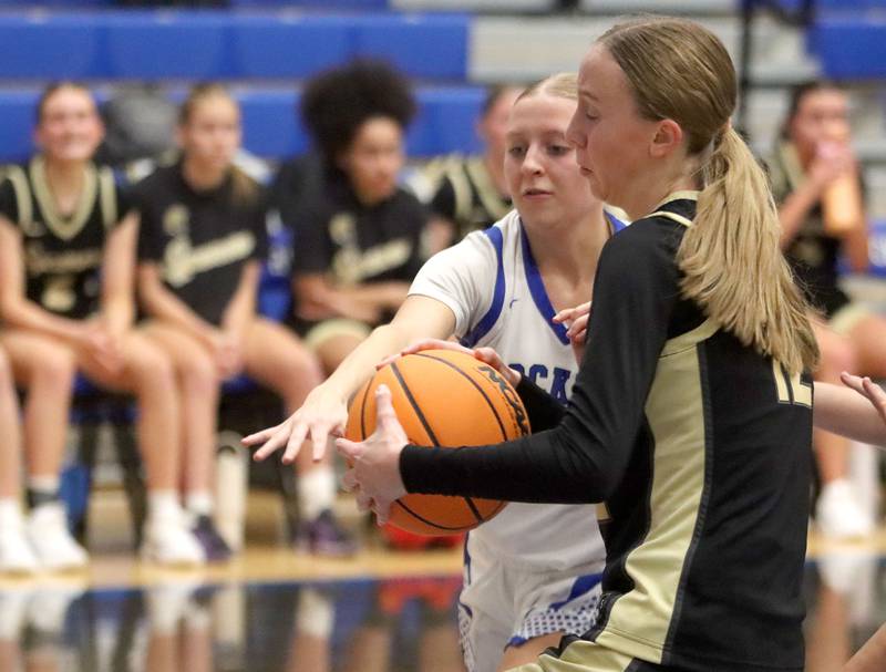 Burlington Central’s Ashley Waslo, left, battles Sycamore’s Sadie Lang for the ball in girls basketball at Burlington Central High School in Burlington on Tuesday, November 18, 2025.