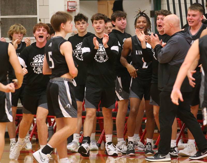 Members of the Kaneland boys basketball team react after defeating L-P in overtime on Tuesday, Dec. 12, 2023 in Sellett Gymnasium.