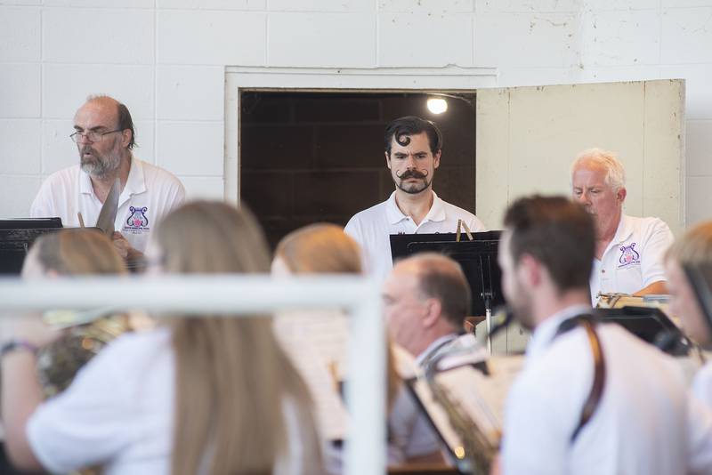 Percussionist Jeremy VanDrew (middle) focuses on his craft Thursday, June 16, 2022 during the performance. VanDrew has played in the Dixon Municipal Band for nearly 20 years now.
