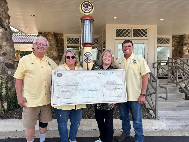 A community group that organizes the Fizz Ehrler Memorial Turning Back Time Car Show poses with outgoing board member Robert L. “Bob” Brown. Brown helped organize the 50/50 raffle and volunteered yearly for the event, which will return to downtown Sycamore on July 27, 2025.
