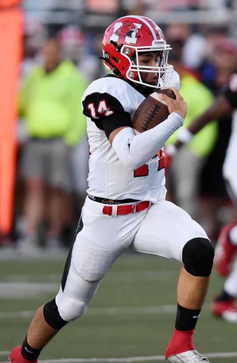 Joe Lewnard/jlewnard@dailyherald.com
Maine South quarterback Constantine Coines carries the ball for a first-quarter touchdown at Warren Thursday.